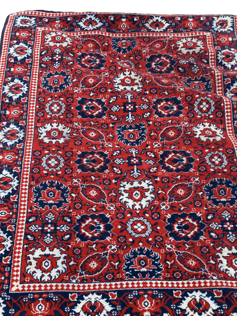 Fine red colored rug with intricate details