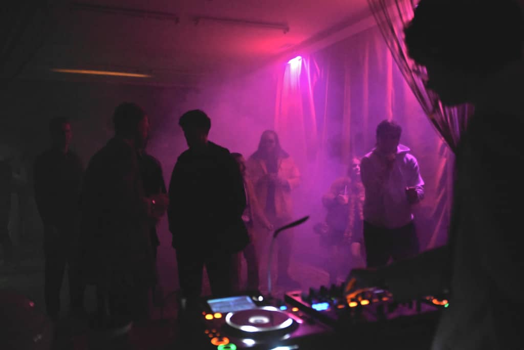 People dancing in pink lighting